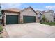Charming brick home featuring a three-car garage, manicured lawn, and decorative exterior details at 2190 Coyote Creek Dr, Fort Lupton, CO 80621