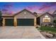 Charming brick home featuring a three-car garage and a well-maintained front yard with a concrete driveway at 2190 Coyote Creek Dr, Fort Lupton, CO 80621