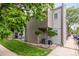 Townhome exterior with mature trees, manicured lawn, and an inviting entrance, plus two AC units at 5300 E Cherry Creek South Dr # 324, Denver, CO 80246