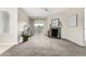 Cozy living room featuring a fireplace, neutral carpet, and access to an outdoor patio at 5300 E Cherry Creek South Dr # 324, Denver, CO 80246
