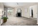 Bright living room boasts a fireplace, sliding doors to a patio, and neutral carpeting at 5300 E Cherry Creek South Dr # 324, Denver, CO 80246