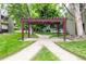 Charming pergola-covered walking path through a grassy area, connecting to community amenities at 5300 E Cherry Creek South Dr # 324, Denver, CO 80246