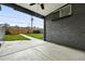 Cozy back patio with a covered area leading to a grassy backyard at 475 S Eliot St, Denver, CO 80219