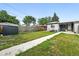 Backyard with walkway to home, lush lawn, and privacy fence at 475 S Eliot St, Denver, CO 80219