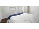 Cozy bedroom with white comforter and hardwood floors at 475 S Eliot St, Denver, CO 80219