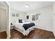 Bright bedroom features hardwood floors and large windows at 475 S Eliot St, Denver, CO 80219