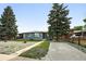 Charming single-story home with a gray exterior, well-maintained lawn, and mature landscaping at 475 S Eliot St, Denver, CO 80219