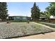 Charming single-story home with a gray exterior, well-maintained lawn, and mature landscaping at 475 S Eliot St, Denver, CO 80219