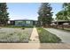 Charming single-story home with a gray exterior, well-maintained lawn, and mature landscaping at 475 S Eliot St, Denver, CO 80219