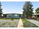 Charming single-story home with a gray exterior, well-maintained lawn, and mature landscaping at 475 S Eliot St, Denver, CO 80219