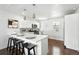 Modern kitchen with white cabinets, sleek countertops, stainless steel appliances, and a functional island at 475 S Eliot St, Denver, CO 80219