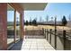 Sunny balcony overlooking a green space with views of trees and distant structures at 1440 Little Raven St # 107, Denver, CO 80202
