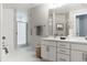 Bathroom features a double vanity, sleek countertops, modern fixtures, and walk in shower at 1440 Little Raven St # 107, Denver, CO 80202