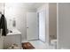 Bright bathroom with white tile, modern fixtures, and an open door to another room at 1440 Little Raven St # 107, Denver, CO 80202