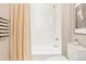 Clean white bathroom featuring a bathtub with shower and decorative accents at 1440 Little Raven St # 107, Denver, CO 80202