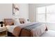 Bedroom features a cozy bed with stylish bedding, a modern nightstand, and a bright window at 1440 Little Raven St # 107, Denver, CO 80202