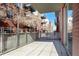Exterior of an apartment building showing balcony with gray railings and brick facade at 1440 Little Raven St # 107, Denver, CO 80202