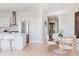 Bright dining area adjacent to kitchen, with a round table, four chairs, and stylish decor at 1440 Little Raven St # 107, Denver, CO 80202