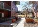 Exterior view of brick apartment building with courtyard, showcasing landscaping and architectural details at 1440 Little Raven St # 107, Denver, CO 80202