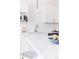 Bright kitchen featuring white cabinets, modern fixtures, stainless appliances, and a marble countertop at 1440 Little Raven St # 107, Denver, CO 80202