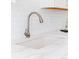 Close-up of the kitchen sink with a modern faucet and white countertops at 1440 Little Raven St # 107, Denver, CO 80202