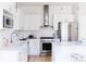 Clean, white kitchen with subway tile backsplash, stainless steel appliances, and marble countertops at 1440 Little Raven St # 107, Denver, CO 80202