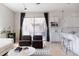 Open-concept living area connects to modern kitchen, features stylish decor and natural light at 1440 Little Raven St # 107, Denver, CO 80202