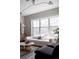 Sunlit living room featuring a comfortable sofa, large windows, and stylish decor at 1440 Little Raven St # 107, Denver, CO 80202