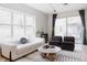 Cozy living room featuring large windows, a comfortable sofa, modern decor, and lots of natural light at 1440 Little Raven St # 107, Denver, CO 80202