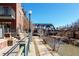Picturesque waterfront walkway by a brick apartment building with views of trees and a nearby bridge at 1440 Little Raven St # 107, Denver, CO 80202