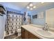 Bathroom featuring ample counter space, large mirror and neutral shower curtain at 9113 E 36Th Ave, Denver, CO 80238