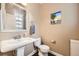 Charming half-bathroom with pedestal sink, modern fixtures, and stylish decor at 9113 E 36Th Ave, Denver, CO 80238