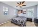 Well-lit bedroom with ceiling fan, comfortable bed and art pieces hanging above bed at 9113 E 36Th Ave, Denver, CO 80238