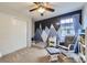 Cozy bedroom with mountain mural, closet and glider chair and ottoman at 9113 E 36Th Ave, Denver, CO 80238