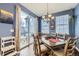 Bright dining room featuring sliding glass door to outdoor space, a modern chandelier, and hardwood floors at 9113 E 36Th Ave, Denver, CO 80238