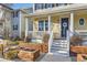 Lovely home with inviting entrance, a cozy porch, and charming planter box landscaping at 9113 E 36Th Ave, Denver, CO 80238