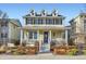 Charming home with a welcoming front porch, dormer windows, and manicured landscaping at 9113 E 36Th Ave, Denver, CO 80238