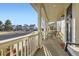 Inviting front porch with columns, swing and chairs, offering a relaxing outdoor space at 9113 E 36Th Ave, Denver, CO 80238