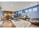 Spacious living room with hardwood floors, stylish furniture, and bright, airy windows at 9113 E 36Th Ave, Denver, CO 80238