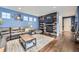 Cozy living room with fireplace, hardwood floors, comfortable seating, and stylish decor at 9113 E 36Th Ave, Denver, CO 80238