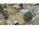 Aerial view of the home featuring a spacious backyard with mature trees, a trampoline and shed at 6576 S Lincoln St, Centennial, CO 80121