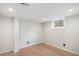 Finished basement area with wood-look flooring, recessed lighting, and a bright, clean aesthetic at 6576 S Lincoln St, Centennial, CO 80121