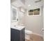 Updated basement bathroom featuring a modern vanity, toilet, and a window for natural light at 6576 S Lincoln St, Centennial, CO 80121