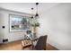 Cozy dining area features a glass table, stylish pendant lights, and a window providing ample natural light at 6576 S Lincoln St, Centennial, CO 80121