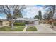 Charming single-story home featuring a brick facade, a well-manicured lawn, and an attached garage at 6576 S Lincoln St, Centennial, CO 80121