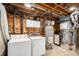 Utility room featuring a washer, dryer, water heater, and plenty of room for storage at 6576 S Lincoln St, Centennial, CO 80121