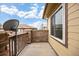 Cozy balcony with stone wall, wooden railing, and beautiful blue sky view at 6702 S Winnipeg Cir # 101, Aurora, CO 80016