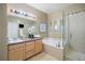 Bathroom featuring a soaking tub, glass-enclosed shower, and vanity sink at 6702 S Winnipeg Cir # 101, Aurora, CO 80016