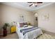 Comfortable bedroom with tray ceiling, yellow nightstands, and neutral walls at 6702 S Winnipeg Cir # 101, Aurora, CO 80016
