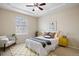 Inviting bedroom with tray ceiling, ceiling fan, and great natural light at 6702 S Winnipeg Cir # 101, Aurora, CO 80016